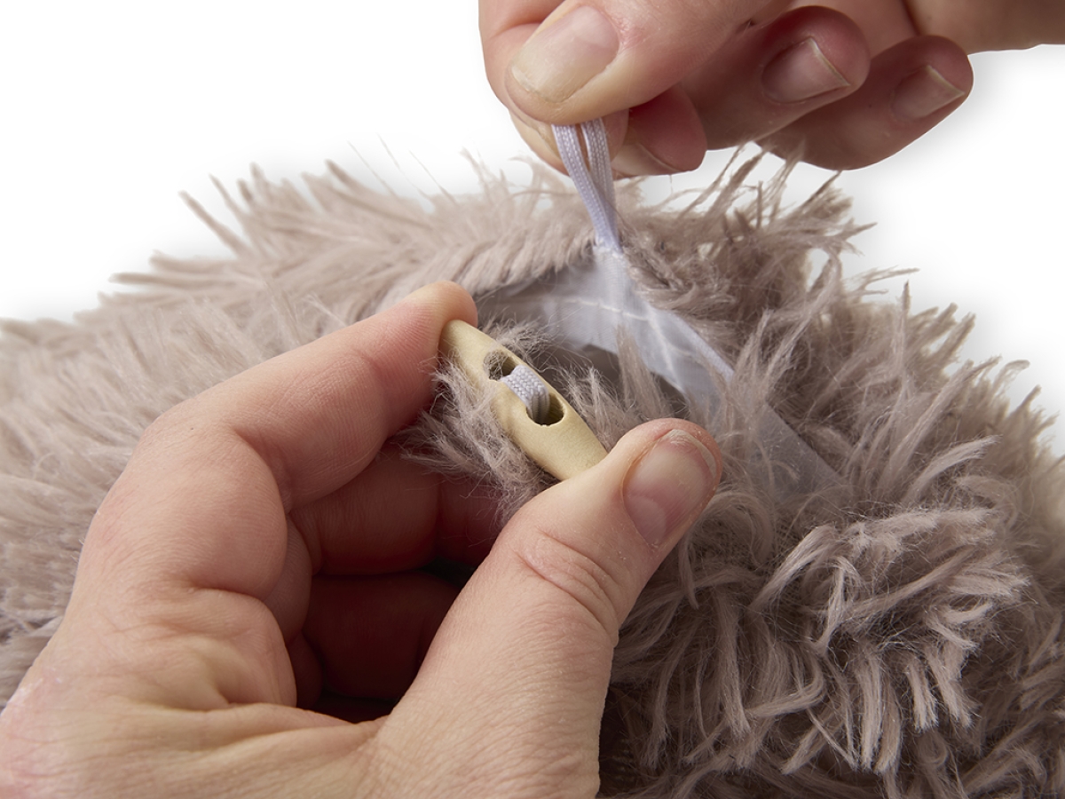 Savic Snuggle Tunnel Warm Grey, shown in donut shape with cushion and two entrances